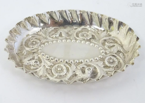 A Victorian silver pin tray with embossed decoration