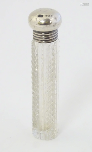 A cut glass scent bottle with silver top hallmarked