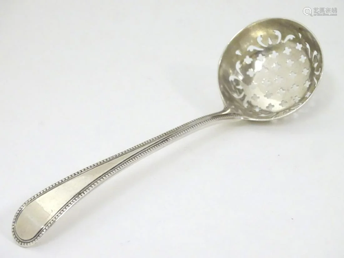 A silver sifter spoon. 6 3/4'' long