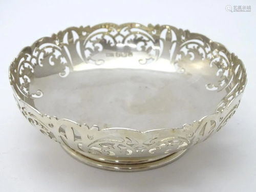 A silver dish with fretwork decoration hallmarked