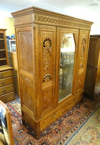 A carved three door Breton armoire with a heavily