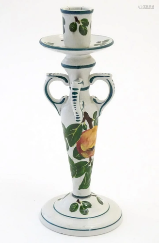 A Wemyss candlestick decorated with apples and l…