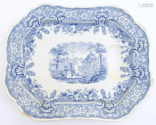 A large blue and white, tree and well stoneware platter