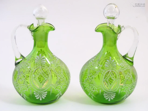 A pair of Victorian green glass small decanters /