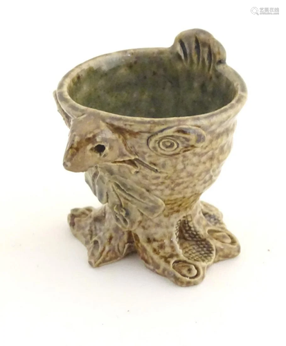 A novelty stoneware egg cup modelled in the style…