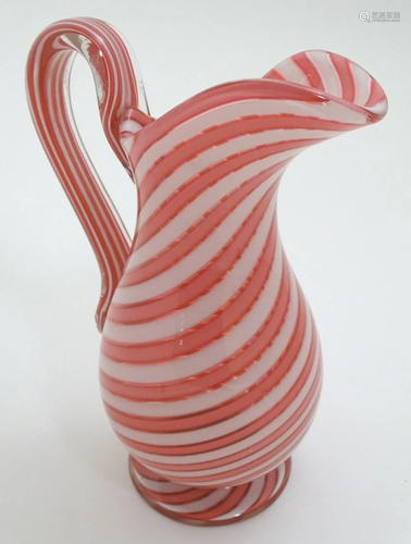 A 19thC water jug with pink and white banded candy