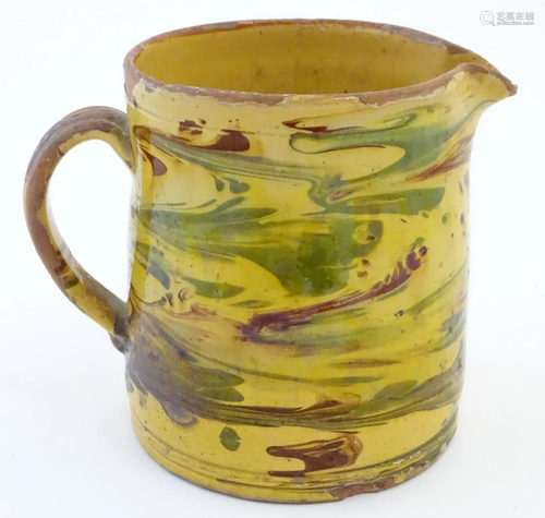 A 19thC studio pottery slipware jug with a yellow