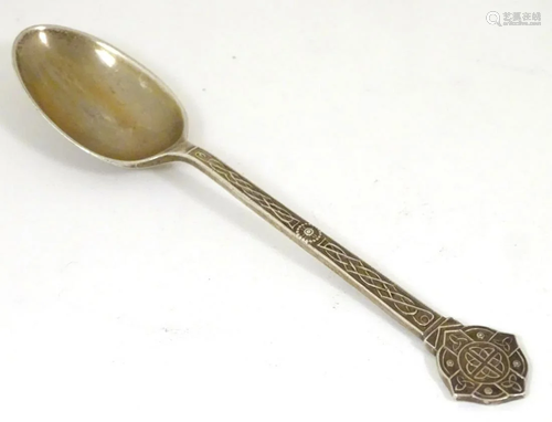 A silver teaspoon with Celtic decoration and engraved