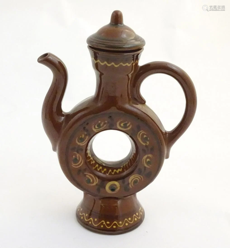 An slipware lidded wine ewer with a ring shape…