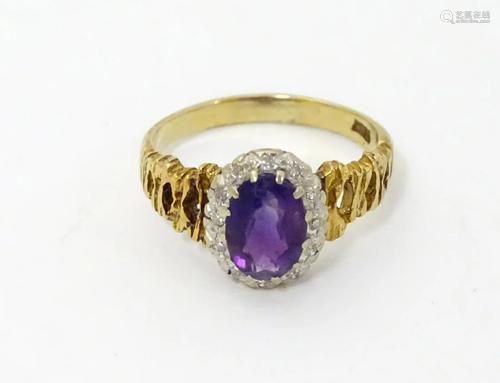 An 18ct gold ring set with central amethyst border…