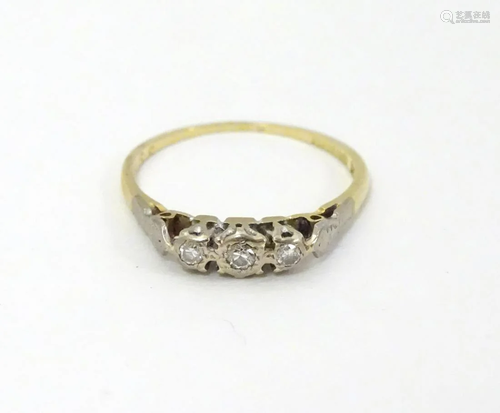 An 18ct gold ring set with trio of diamonds