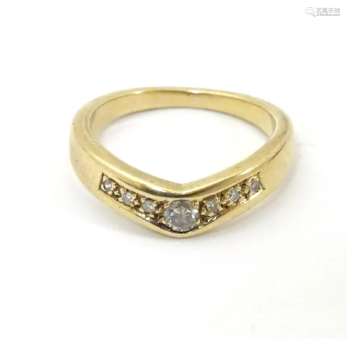 An 18ct gold ring set with diamonds in a wishbone