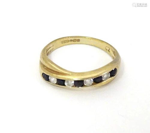 A 9ct gold ring set with white and black stones