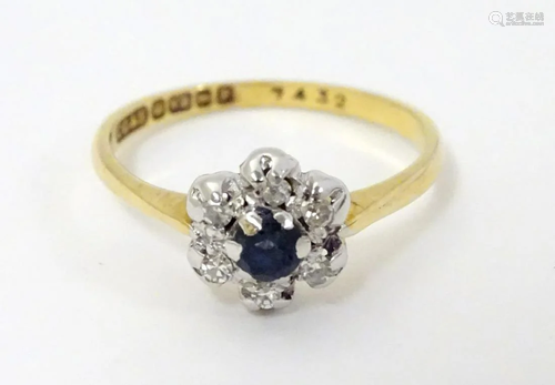 An 18ct gold ring set with central sapphire border…