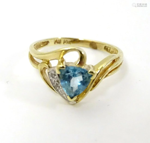 A 10k gold ring set with central topaz and chip …