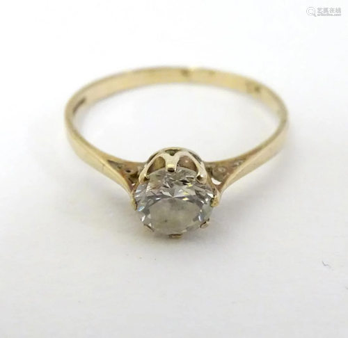 A 9ct gold ring set with white stone solitaire