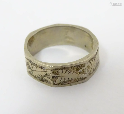 A white metal ring with foliate decoration. Marked '15'