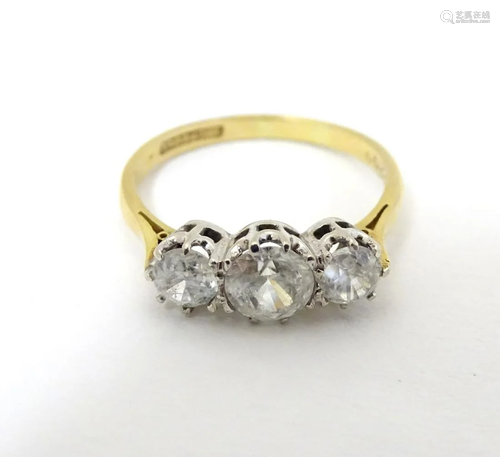 A ring set with three graduated white stones and …