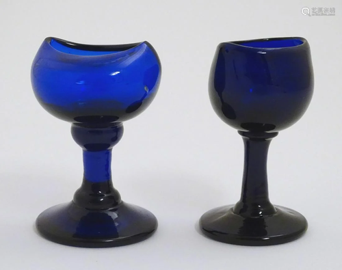 Two late 19th C blue glass pedestal eye baths. Tallest