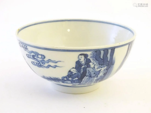 A Chinese blue and white bowl depicting scenes of