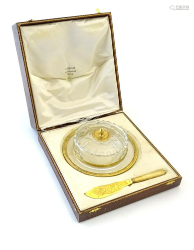 A glass butter dish and cover with French silver gilt