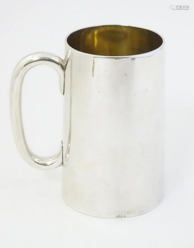 A white metal mug with loop handle 41/2'' high.