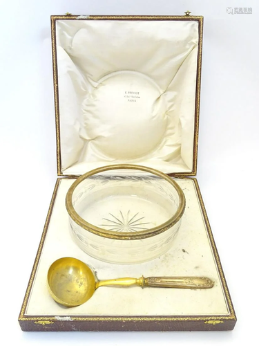 A cut and etched glass bowl with French silver gilt rim