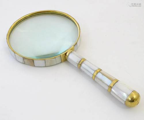 A 20thC magnifying glass with a brass and moth…