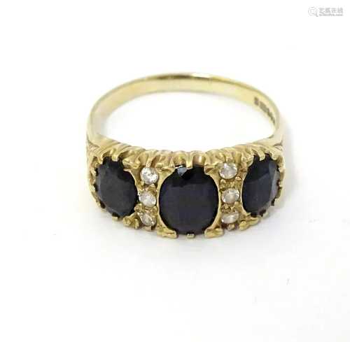 A 9ct gold ring set with white and dark stones