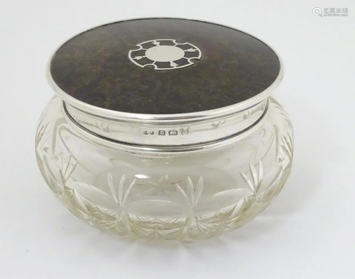 A cut glass dressing table pot with silver and