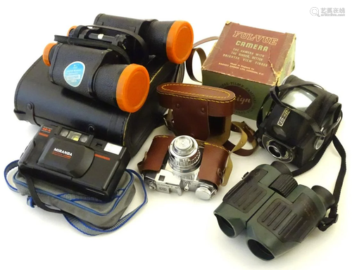 An assortment of vintage cameras and binocul…