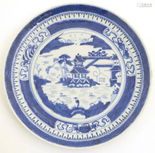 A Chinese blue and white plate with hand painted