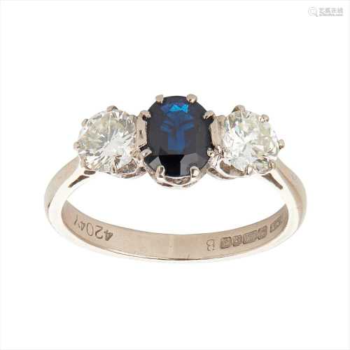 A sapphire and diamond set three stone ring