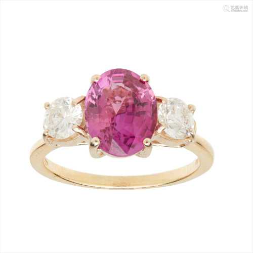 A pink sapphire and diamond set three stone ring