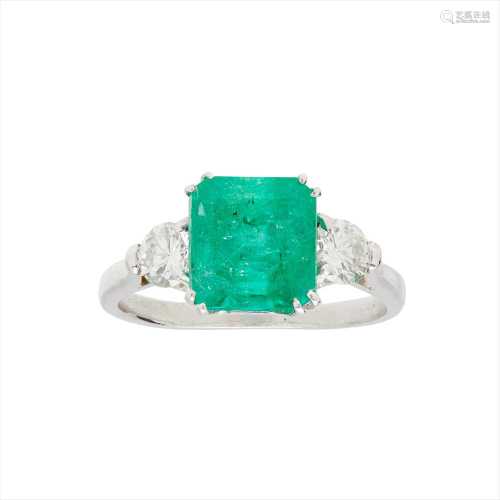 An emerald and diamond set three stone ring
