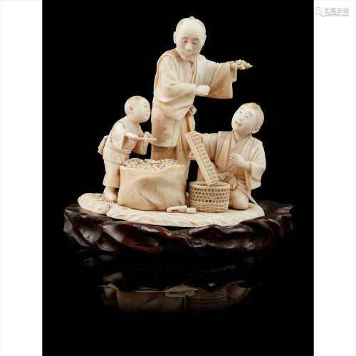 Y JAPANESE IVORY OKIMONO GROUP SCENE OF A PEANUT SELLER MEIJI PERIOD