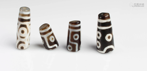 A Group of Four Dzi Beads