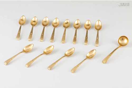 A set of 12 tea spoons and sugar shovel