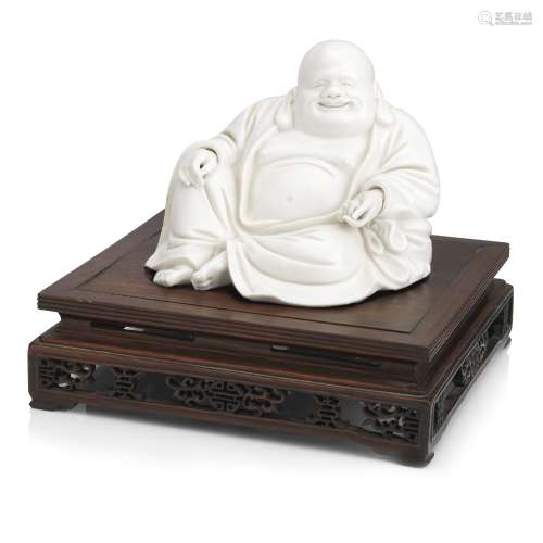 A well-modelled blanc-de-chine figure of Budai on wood stand Early Qing Dynasty