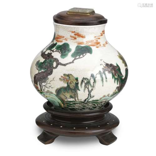 A famille verte jar on wood stand and with wood cover set with a jade plaque Qing Dynasty, 19th c...