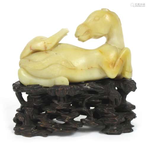 A pale grey-yellow stone carved horse on wood stand Ming style but 19th century (2)
