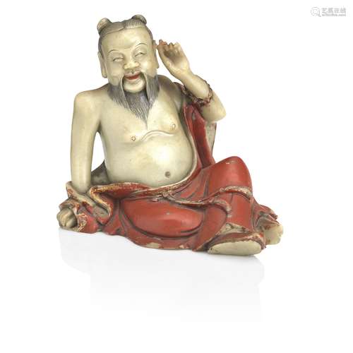 A gilt and lacquer decorated soapstone figure of a luohan Qing Dynasty, 18th century