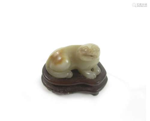 A carved jade lion-dog and wood stand (2)
