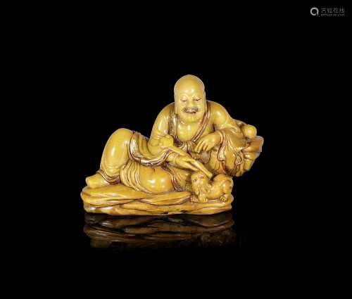 A gilt-decorated soapstone carving of the Laughing Lion Luohan 20th century (2)