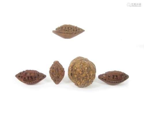 A small collection of carved peach stones and walnut shells 19th century (7)