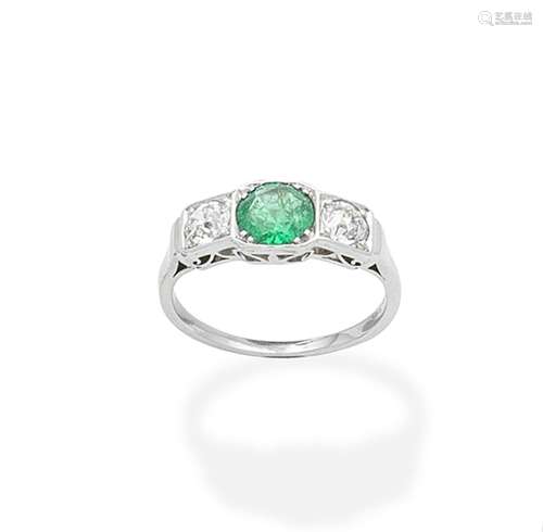 An emerald and diamond three-stone ring