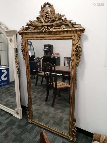 An 18th Century gilded mirror, ornate pediment with foliate, torch and quiver decoration, foliate