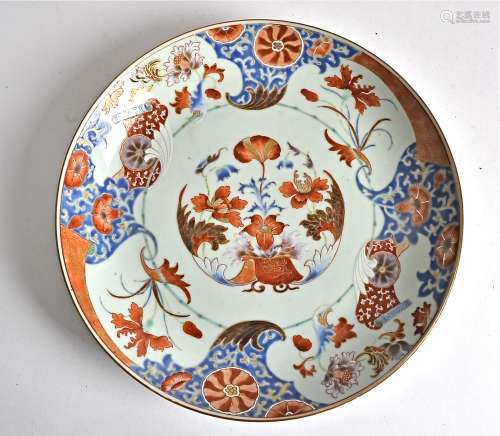 A Chinese export plate in the Imari pattern, decorated with flowers and scrolls, predominately in