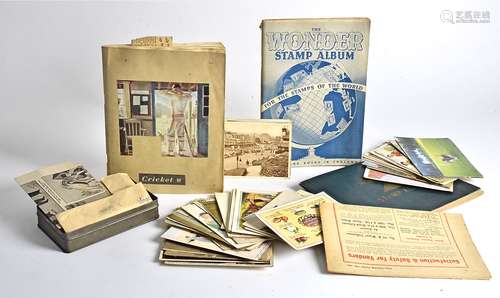 A small quantity of stamps and postcards, together with a scrapbook of cricket clippings, the