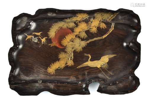 A Japanese Meiji period hardwood lacquered panel, the naturalistic shaped plaque decorated with